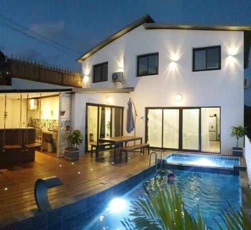 une maison avec une piscine en face d'une maison dans l'établissement Lilie location manapany 4 étoiles, à Petite Île