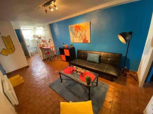 a living room with a couch and a table at Pause Paisible à Blois « Comme à « BROOKLYN » in Blois