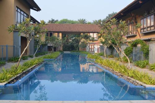 La alberca dentro o cerca de Ganga kutir Residency Villa