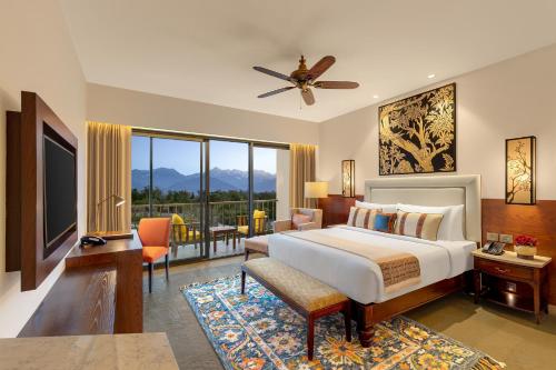 a bedroom with a bed and a large window at Storii By ITC Hotels, Amoha Retreat Dharamshala in Dharamshala