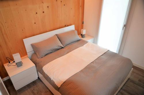 a bedroom with a large bed with a wooden wall at Al Leone di San Marco LUXURY & RELAX in Noale