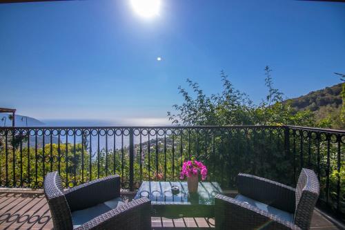a patio with a table and chairs on a balcony at Lissiya Hotel in Faralya