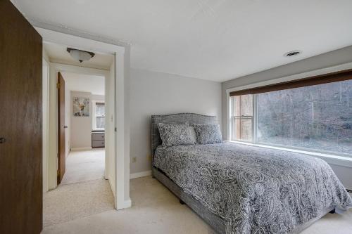 a bedroom with a bed and a window at Killington Mountain Home! HotTub & 5 min to Skiing! in Killington