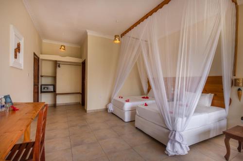 Ένα ή περισσότερα κρεβάτια σε δωμάτιο στο Sunset Kendwa Beach Hotel