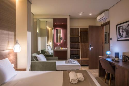 a hotel room with a bed and a bathroom at Metropole Urban Hotel in Heraklio Town