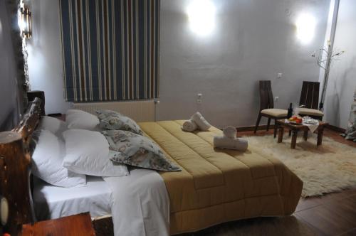 a bedroom with a large bed with white pillows at Pasithei in Karpenision