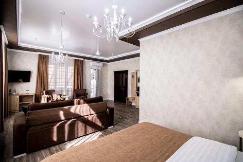 a bedroom with a bed and a living room at Гостевой дом Villa Aila in Mineralnye Vody