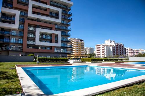 a swimming pool in front of a apartment building at Rocha Tower 13D - Skyline Ocean View in Portimão