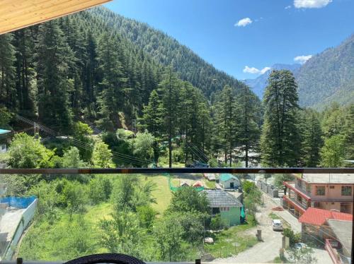 a view from a window of a town in the mountains at Royal Castle in Kasol