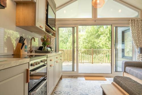 a kitchen with a large glass door leading to a patio at Waterfoot Park in Pooley Bridge