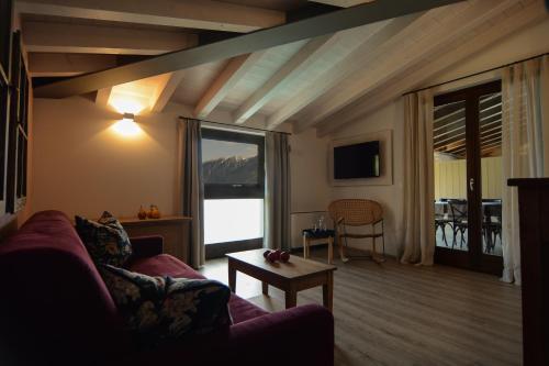 a living room with a couch and a table at Cascina Varini in Gargnano