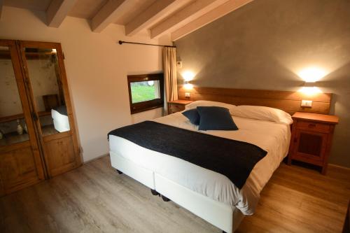 a bedroom with a large bed and a mirror at Cascina Varini in Gargnano