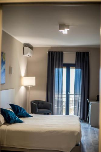 a hotel room with a bed and a window at Il Gelso Guest House in Catanzaro