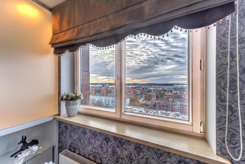 a window with a view of a city at Apartment near center in Klaipėda