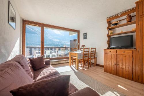 a living room with a couch and a television at Nice Studio With Balcony In Chamonix in Chamonix