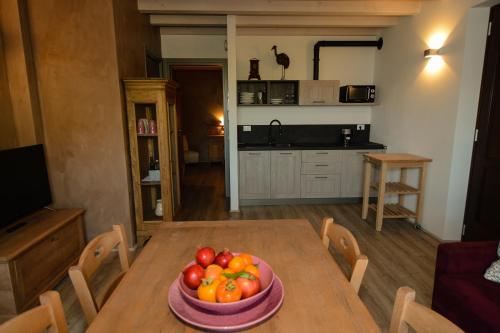 a bowl of fruit on a wooden table in a kitchen at Cascina Varini in Gargnano