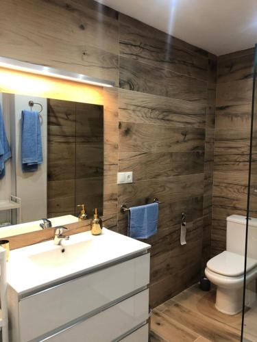 a bathroom with a sink and a toilet and a mirror at Villa Minerva in Arriate