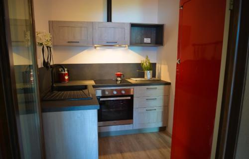 a small kitchen with a stove and a sink at Cascina Varini in Gargnano