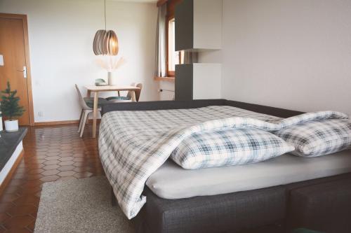 a bedroom with a bed with two pillows on it at Roc d'Orsay F72 in Leysin