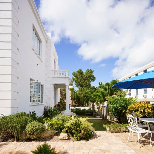a white house with a patio and a table at Oxford House in Hamilton