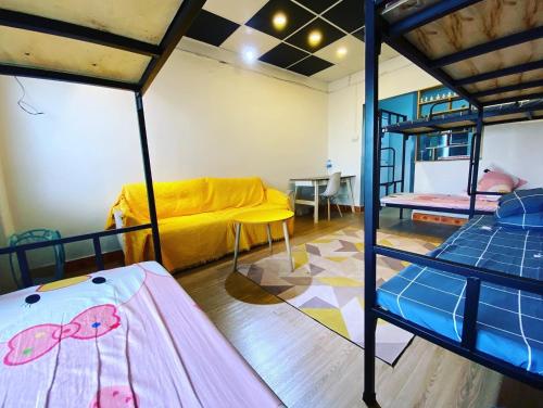 a room with two bunk beds and a couch at 3cuhomestay in Thinh Làng