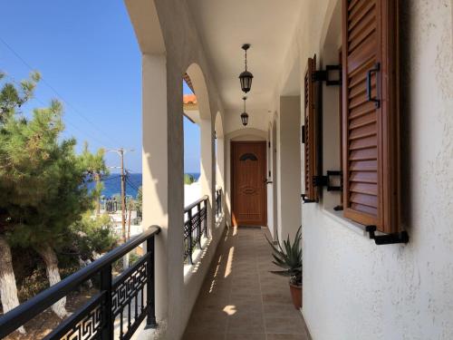 a hallway of a house with a door and a balcony at Nikos Apartments A7 in Gialiskari