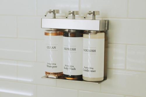 a spice rack in a bathroom with four jars at Mary's Land Farm in Ellicott City