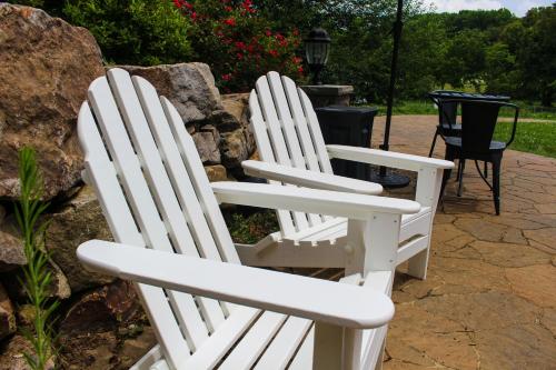 two white adirondack chairs sitting on a patio at Mary's Land Farm in Ellicott City