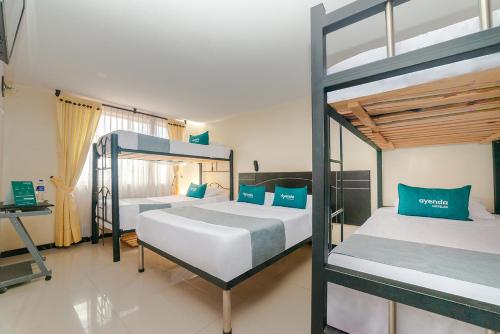 Postel nebo postele na pokoji v ubytování Ayenda Balcon Real