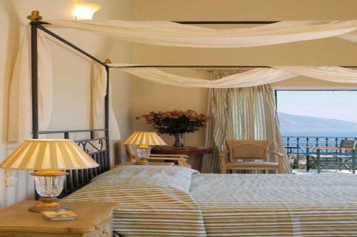 a bedroom with a bed with a view of the ocean at Agnantia Bed & Breakfast in Fiskardho