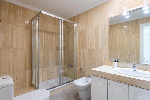 a bathroom with a shower and a toilet and a sink at BLUE SEA II - FRONT BEACH in Puerto de Mogán