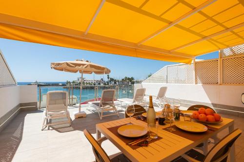 a dining table on the deck of a boat at BLUE SEA I in Puerto de Mogán
