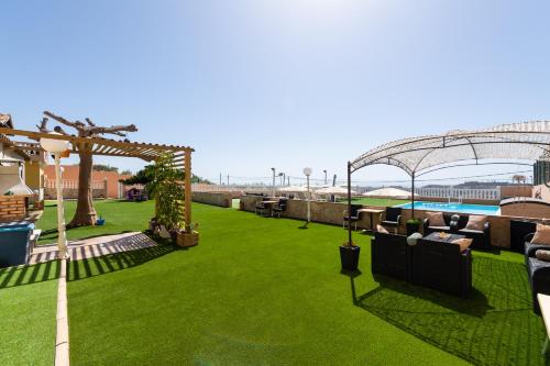 an outdoor area with a lawn and a pool at Casa Adara - Heated pool included in San Bartolomé