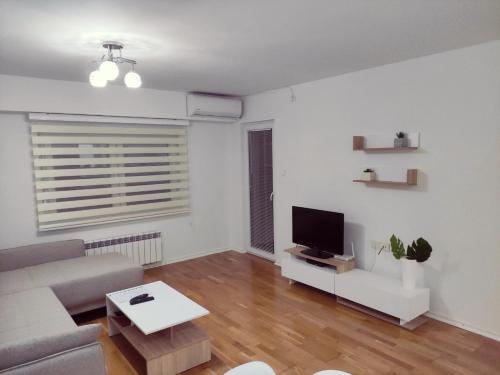 a living room with a couch and a tv at Feels like home 3 in Skopje