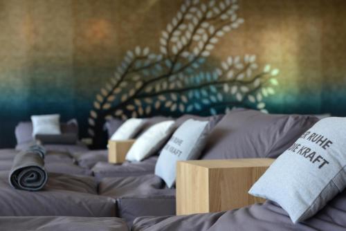 a room with three beds with pillows on them at Hotel Moserhof in Seeboden