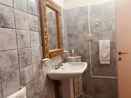 a bathroom with a sink and a mirror at Il Nuraghe del lago Coghinas in Oschiri