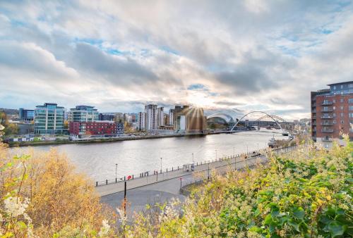 a view of a river in a city with buildings at Swan Apartments 2A Cosy City Break Staycation in Newcastle upon Tyne