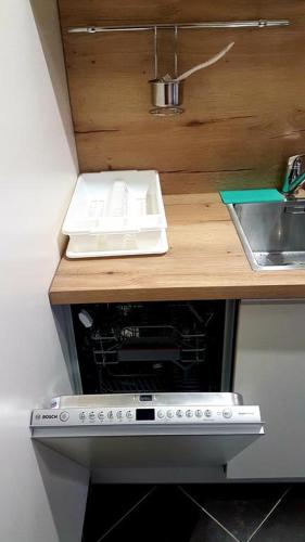 a kitchen counter with a sink and a stove at Apartmán 27, Kamzík in Donovaly
