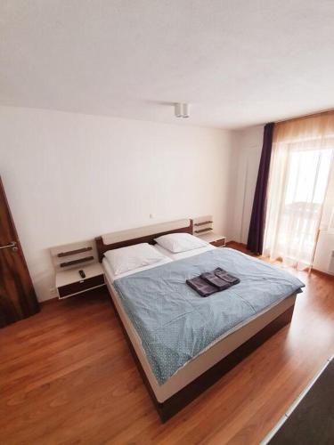 a bedroom with a bed with a blue comforter at Apartmán 27, Kamzík in Donovaly