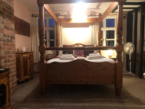 a bed with a wooden frame in a room at The Mug House Inn in Bewdley