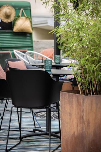 a table and chairs with plants in a room at Home Hotel Uppsala in Uppsala