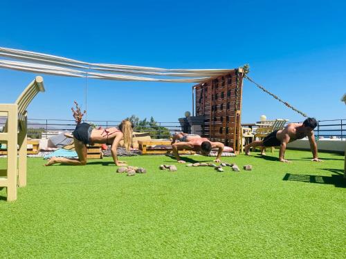 a group of people doing yoga on the grass at Swiss Royal DAHAB in Dahab