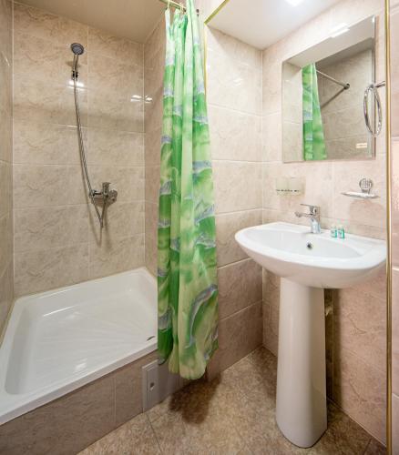 a bathroom with a sink and a bath tub and a sink at New Star Boutique hotel - madrasah Muhammad Mahram 1903 in UNESCO World Heritage Site in Khiva