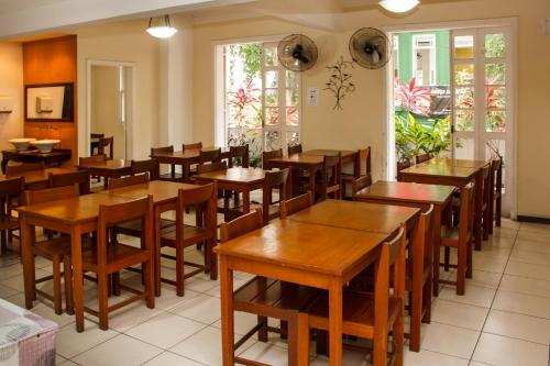 a dining room with wooden tables and chairs at Hotel Carioca in Rio de Janeiro