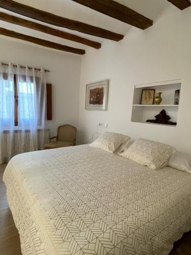 a bedroom with a large white bed in a room at Castillo de Bulbuente de Luis Zueco in Bulbuente