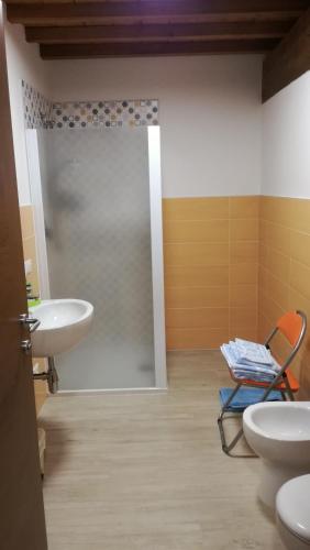 a bathroom with a toilet and a sink and a shower at Agriturismo Corte Lidia in Bellaguarda