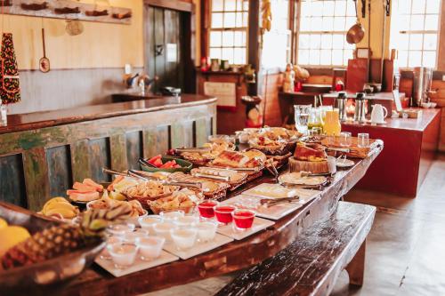 a buffet table with many different types of food at Pousada d'Oleo de Guignard in Tiradentes