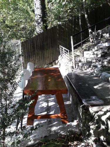 a wooden table and two chairs sitting next to some stairs at Tudor View Apartament in Sinaia