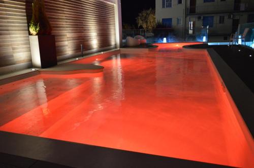 a pool with red lights on top of a building at Hotel Villa Paola in Rimini