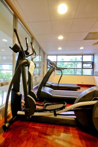 a gym with several tread machines in a room at F Hotel Tainan in Tainan